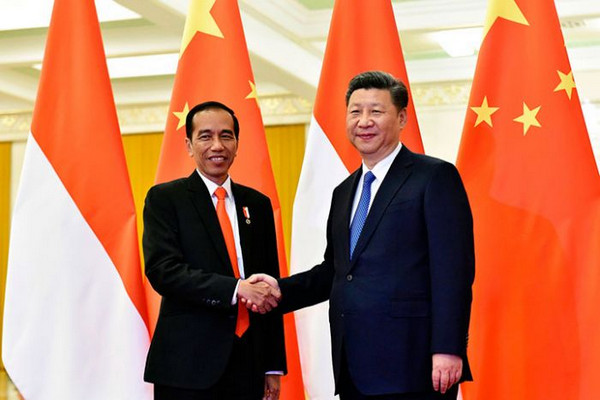 Presiden Joko Widodo (kiri) berjabat tangan dengan Presiden Cina, Xi Jinping, saat pertemuan bilateral di sela-sela KTT OBOR di Beijing. (Foto: AP/Kenzaburo Fukuhara)