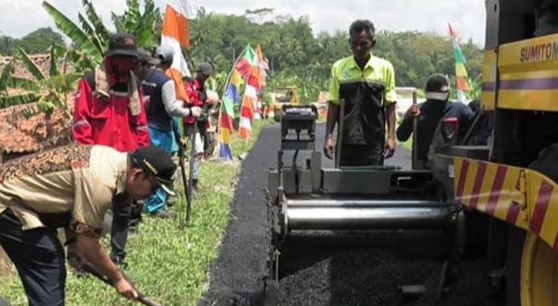 Bupati Banyumas Achmad Husein meratakan aspal memakai sekop saat pengaspalan perdana menggunakan aspal hotmix dengan campuran limbah plastik, Sumber: ANTARA